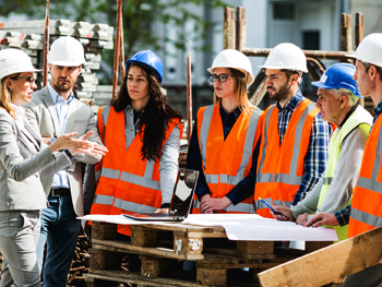 Construction team discussing blueprints